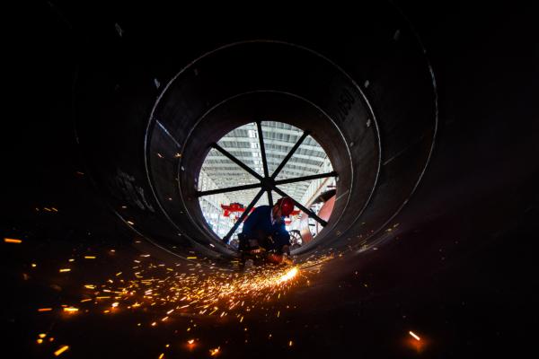 A worker welds building material parts at a factory in Nantong, Jiangsu Province, China, on May 16, 2023. (STR/AFP via Getty Images)