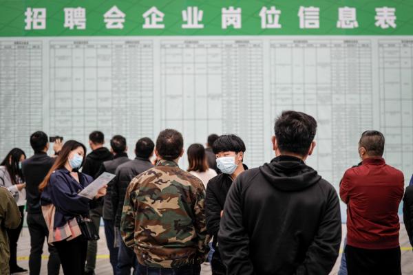 Job applicants read recruitment information at a job fair in Wuhan, Hubei Province, China, on April 21, 2020. (Getty Images)