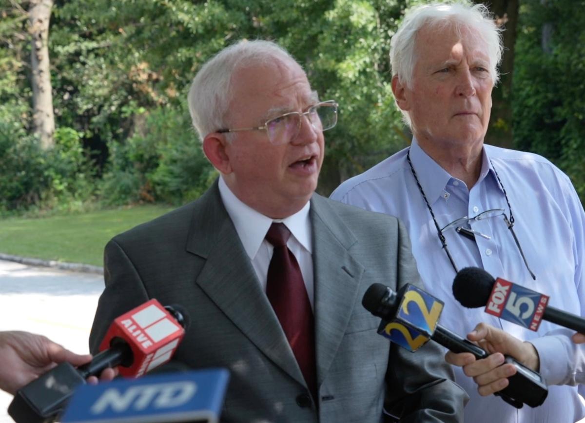 John Eastman (L), former attorney and adviser for former President Donald Trump, speaks with reporters along with his attorney L. David Wolfe outside the Fulton County Jail on Aug. 22, 2023. (Janice Hisle/The Epoch Times via screenshot of NTD video)