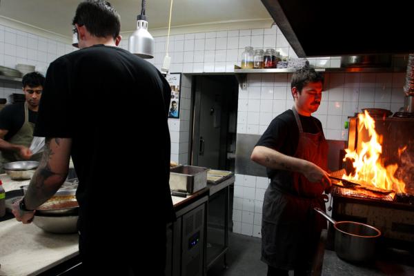 A chef prepares steak for patrons at the Hartsyard restaurant in Sydney, Australia, on June. 5, 2020. (Lisa Maree Williams/Getty Images)
