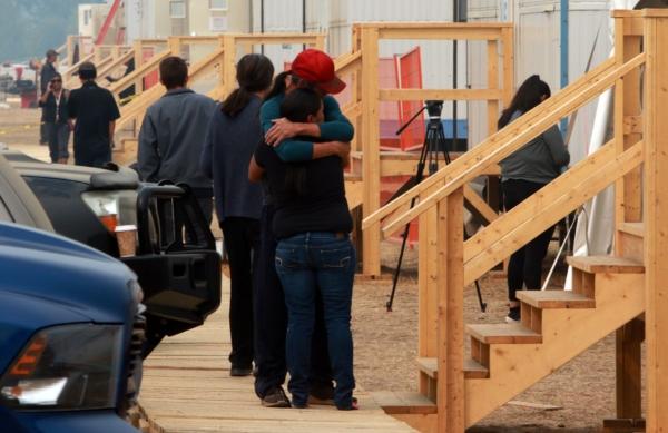 People share a moment at the Tselletkwe Lodge, a safe place for indigenous evacuees and others who've been displaced due to the wildfires in Kamloops, B.C., on Aug. 22, 2023. (The Canadian Press/Chad Hipolito)