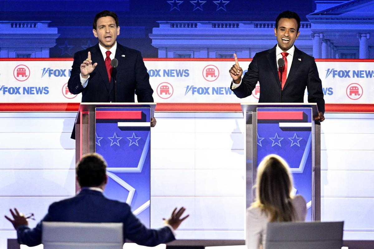 Florida Gov. Ron DeSantis (L) and entrepreneur Vivek Ramaswamy speak during the first Republican presidential primary debate in Milwaukee, Wis., on Aug. 23, 2023. (Brendan Smialowski/AFP via Getty Images)