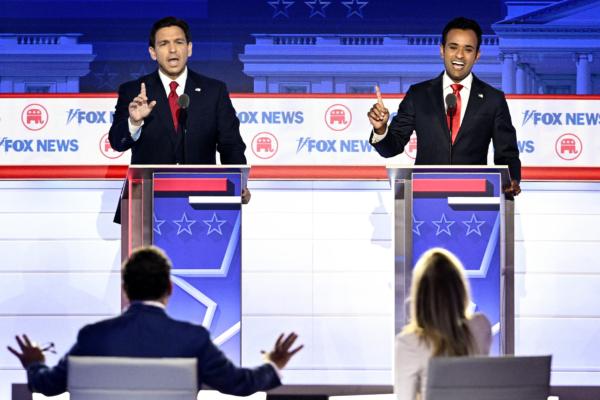 Florida Gov. Ron DeSantis (left) and entrepreneur and author Vivek Ramaswamy speak during the first Republican Presidential primary debate at the Fiserv Forum in Milwaukee, Wis., on Aug. 23, 2023. (BRENDAN SMIALOWSKI/AFP via Getty Images)