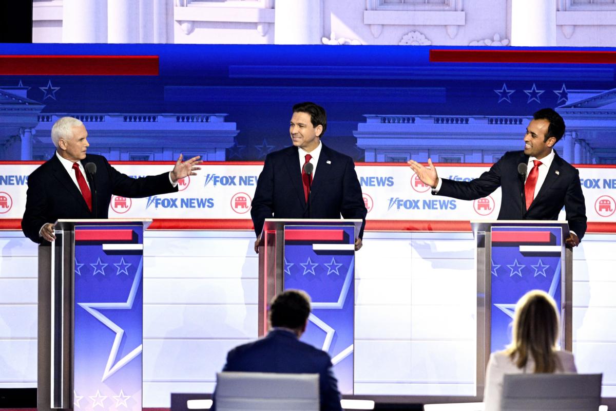 Former Vice President Mike Pence (left) and entrepreneur and author Vivek Ramaswamy (right) gesture toward Florida Gov. Ron DeSantis during the first Republican Presidential primary debate at the Fiserv Forum in Milwaukee, Wis., on Aug. 23, 2023. (Brendan Smialowski/AFP via Getty Images)