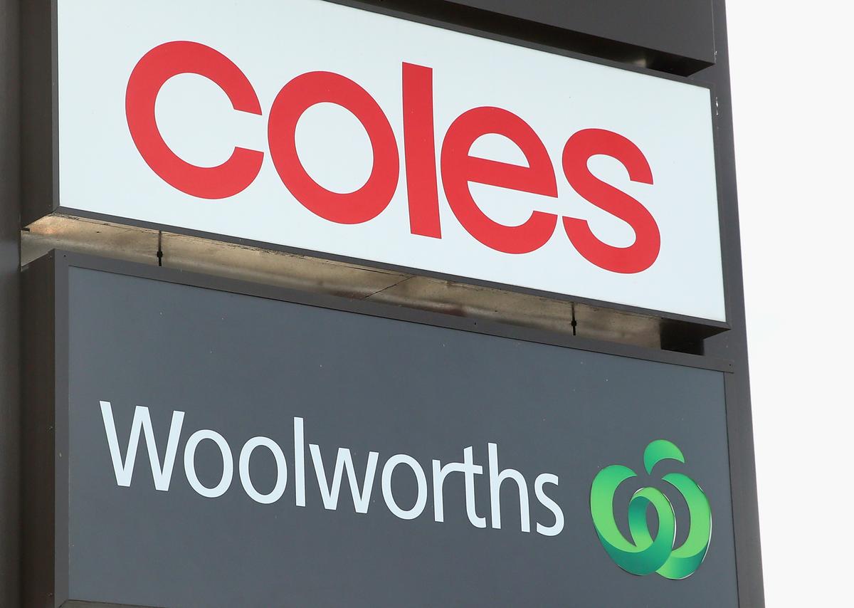 Coles and Woolworths signs are seen outside a shopping centre in Melbourne, Australia, on May 25, 2015. (Quinn Rooney/Getty Images)
