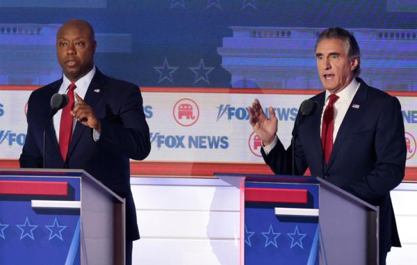 (L-R) Sen. Tim Scott (R-S.C.) and North Dakota Governor Doug Burgum participate in the first debate of the GOP primary season hosted by FOX News at the Fiserv Forum in Milwaukee, Wisconsin, on Aug. 23, 2023. (Win McNamee/Getty Images)