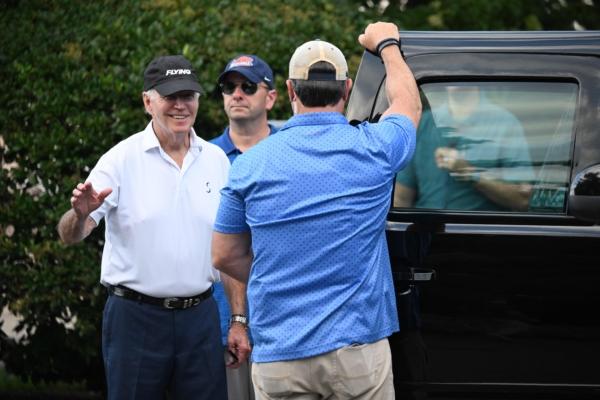 U.S. President Joe Biden waves as he leaves after spending time at the beach, in Rehoboth Beach, Delaware, on August 13, 2023. (Mandel Ngan/AFP via Getty Images)