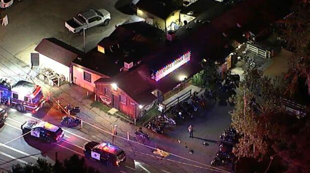 Authorities work at the scene of a fatal shooting at Cook's Corner, a biker bar in rural Trabuco Canyon, Calif., on Aug. 23, 2023. (ABC7 Los Angeles via AP)