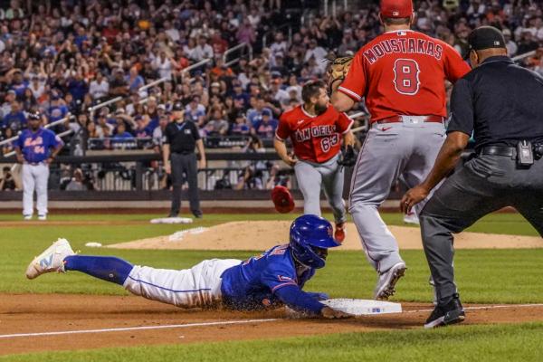 New York Mets Francisco Lindor steals third base during fourth inning, as Los Angeles Angels starter Chase Silseth (63) was struck on the head on a throw from first base during a game in New York on Aug. 26, 2023. (Bebeto Matthews/AP Photo)