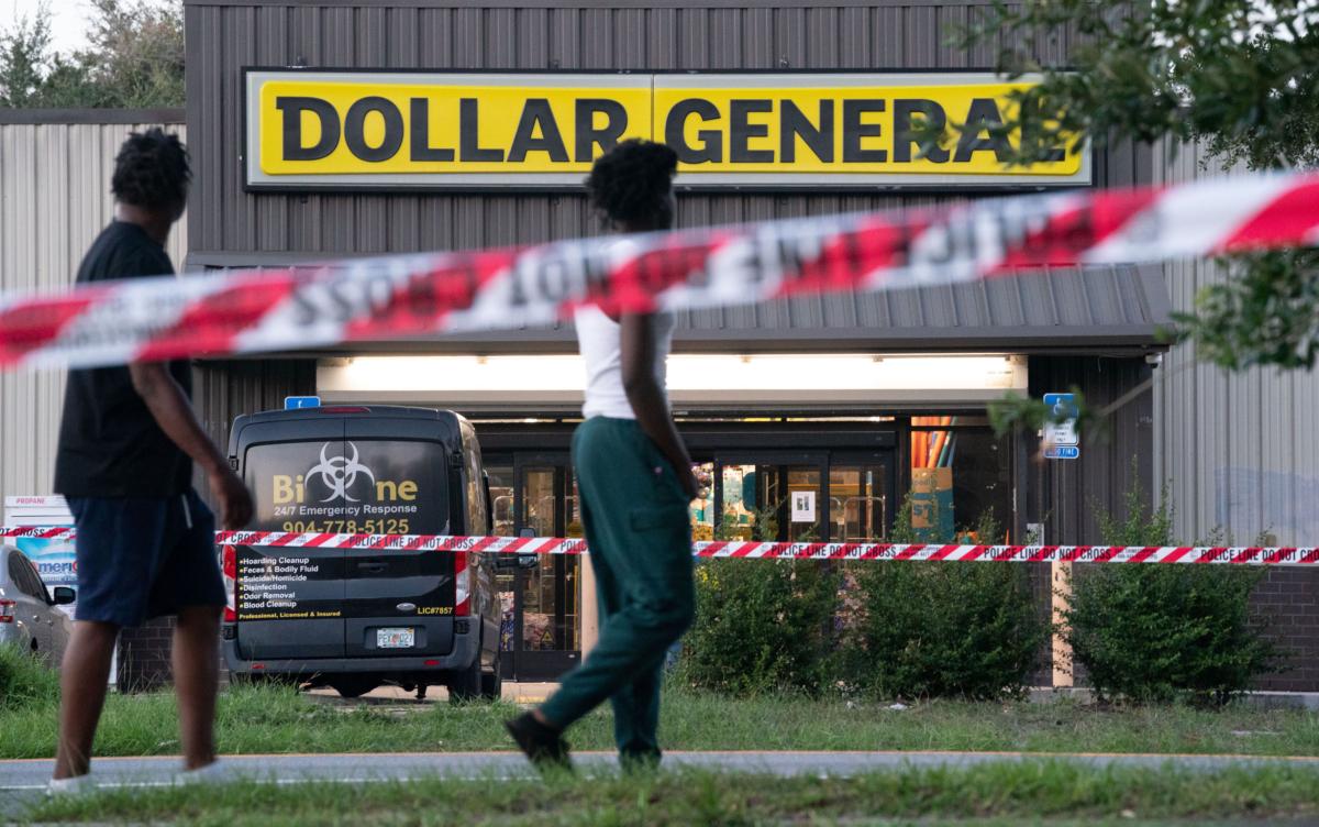 Pedestrians walk past a Dollar General store in Jacksonville, Fla., where three people were shot and killed the day before, on Aug. 27, 2023. (Sean Rayford/Getty Images)