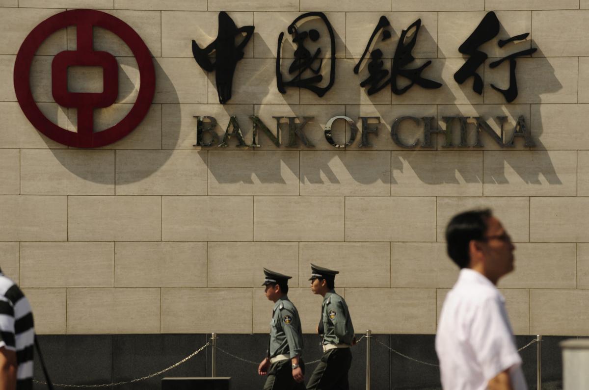 People walk past a branch of the Bank of China in Beijing, on Sept. 11, 2009. (Peter Parks/AFP via Getty Images)