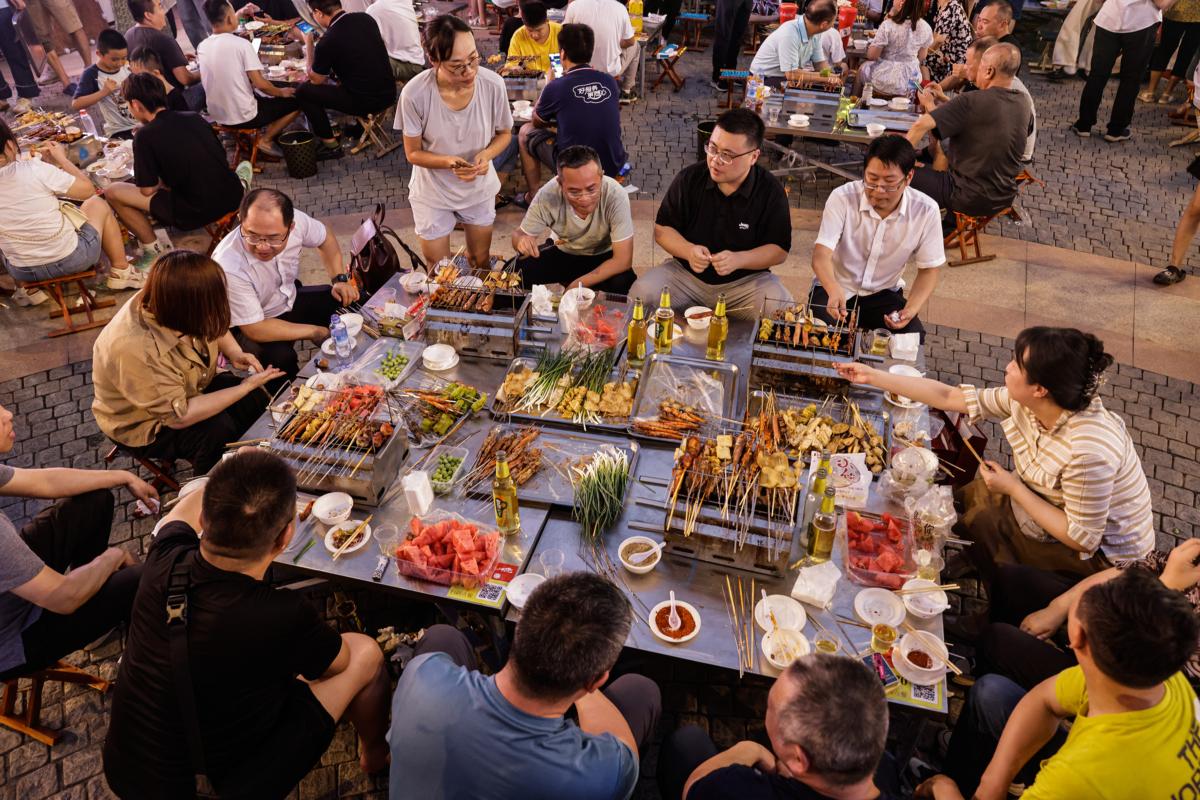 Tourists enjoy a barbecue at Hankou town during Zibo first barbecue festival in Wuhan, Hubei province, China, on July 7, 2023. (Getty Images)