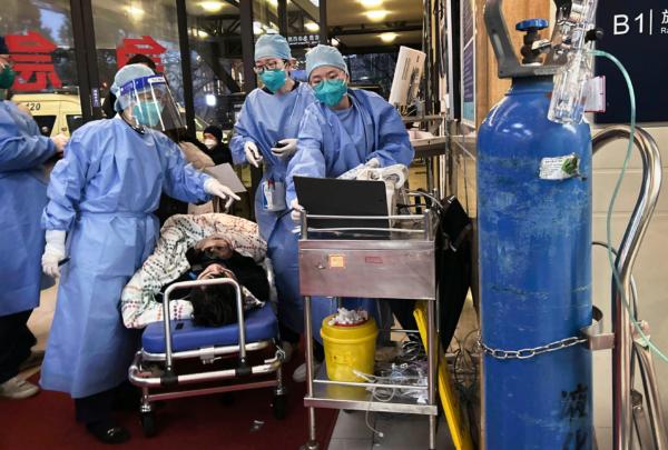 Health care workers attend a COVID patient in Shanghai on Jan. 14, 2023. (Kevin Frayer/Getty Images)
