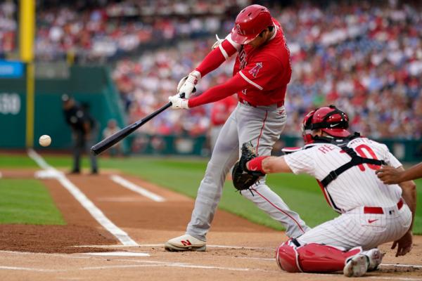 Los Angeles Angels' Shohei Ohtani hits a single against Philadelphia Phillies pitcher Taijuan Walker during the first inning of a baseball game in Philadelphia on Aug. 28, 2023. (Matt Slocum/AP Photo)