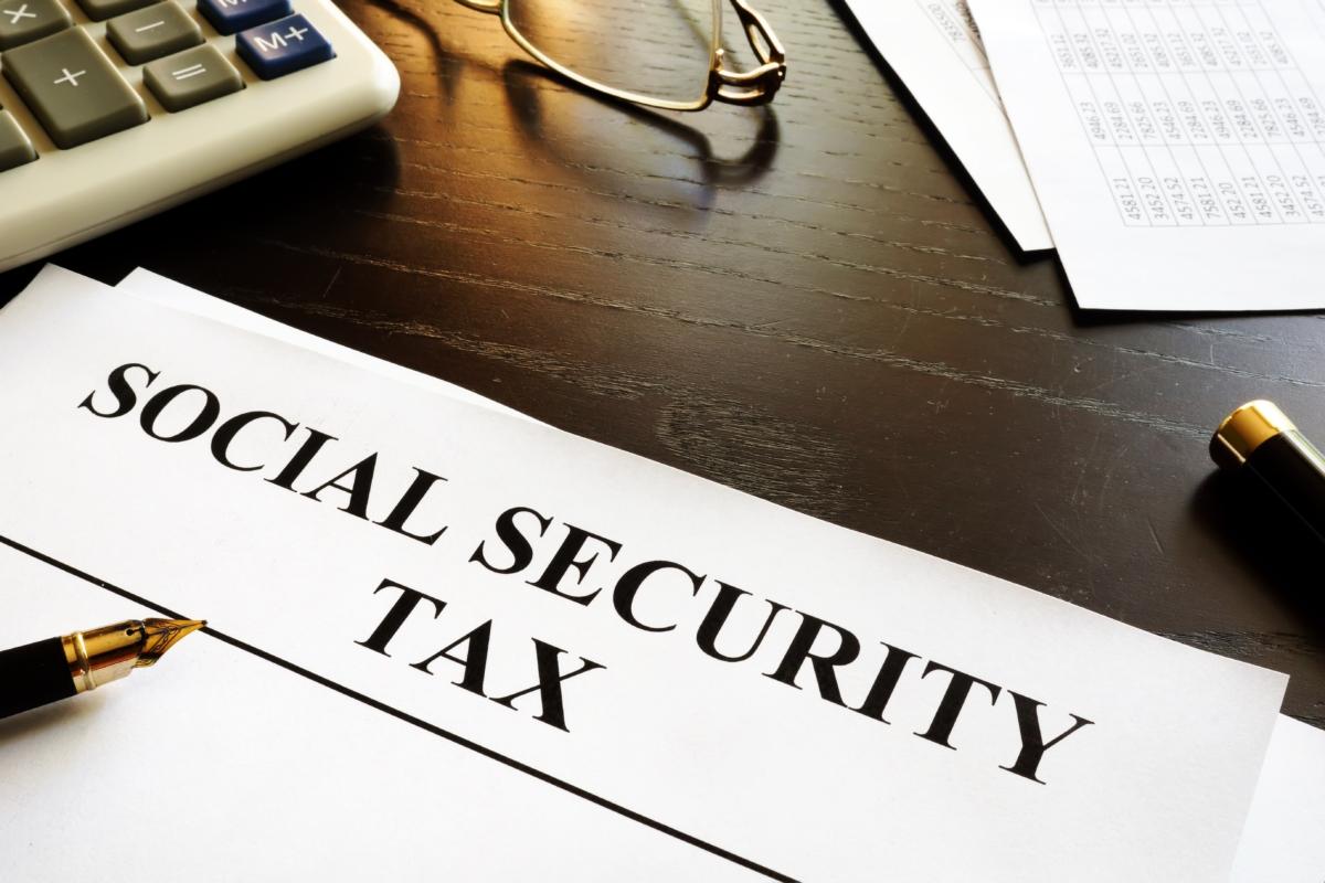 Papers with title social security tax. (Vitalii Vodolazskyi/Shutterstock)