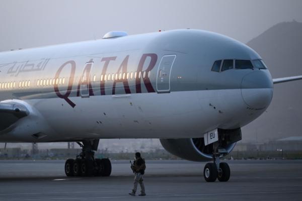 A Qatari security personnel stand guard next to a Qatar Airways aircraft at the airport in Kabul, Afghanistan, on Sept. 10, 2021. (Aamir Qureshi/AFP via Getty Images)