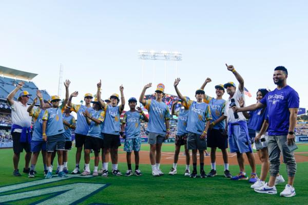 El Segundo players wave during a ceremony honoring the team's victory in the Little League World Series, before a baseball game between the Los Angeles Dodgers and the Arizona Diamondbacks in Los Angeles on Aug. 29, 2023. (Ryan Sun/AP Photo)