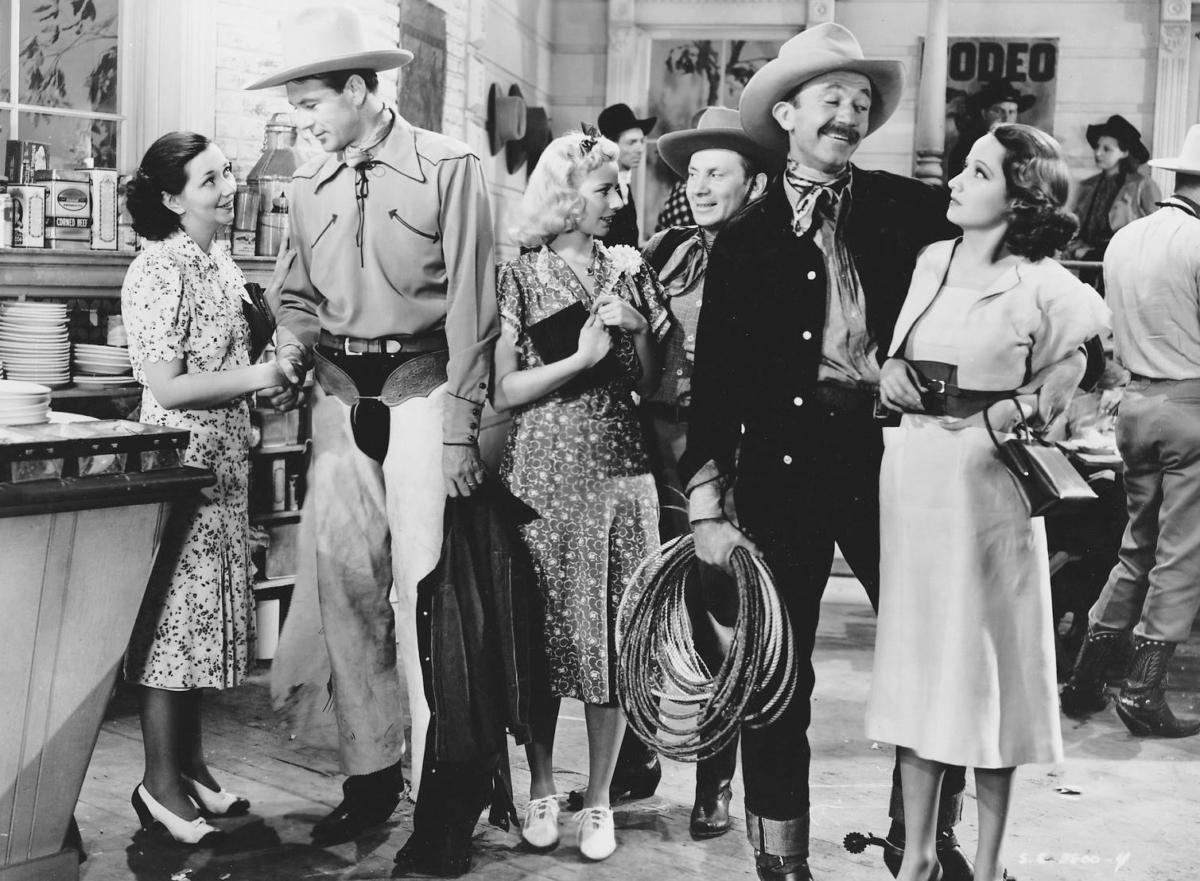 (L–R) Elly (Mabel Todd), Stretch Willoughby (Gary Cooper), Katie Callahan (Patsy Kelly), Buzz (Fuzzy Knight), (Walter Brennan) and Mary Smith (Merle Oberon) in “The Cowboy and the Lady.” (United Artists)