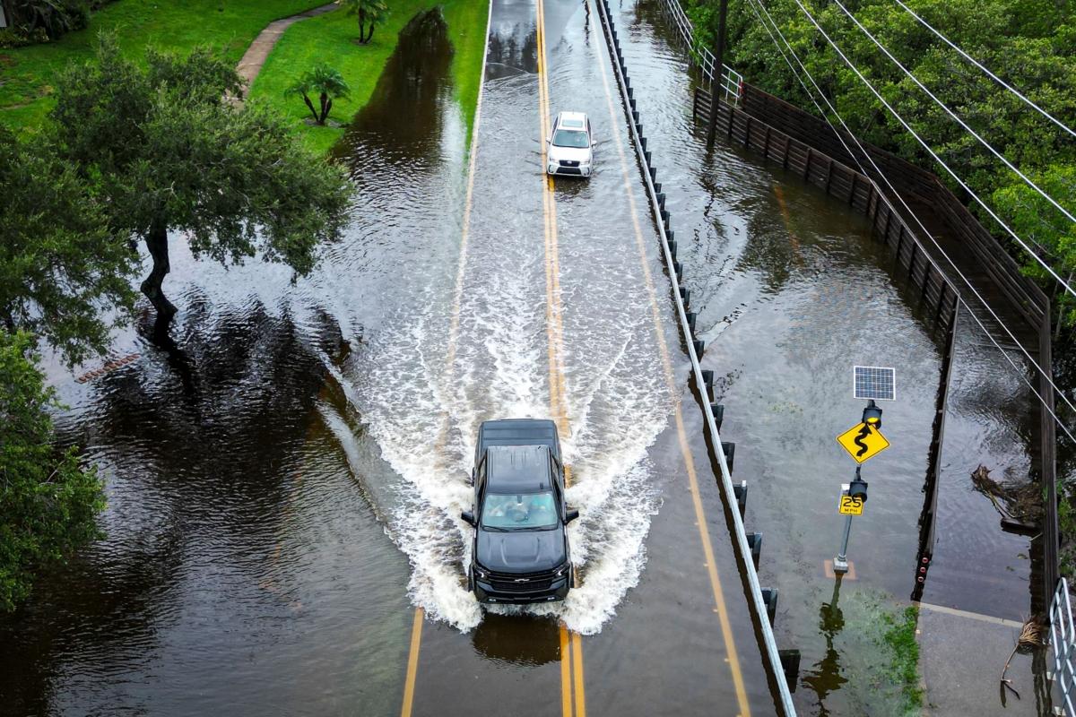 Vehicles attempt to travel on a flooded road in Tampa, Florida, after Hurricane Idalia made landfall on Aug. 30, 2023. (Miguel J. Rodriguez Carrillo/AFP via Getty Images)