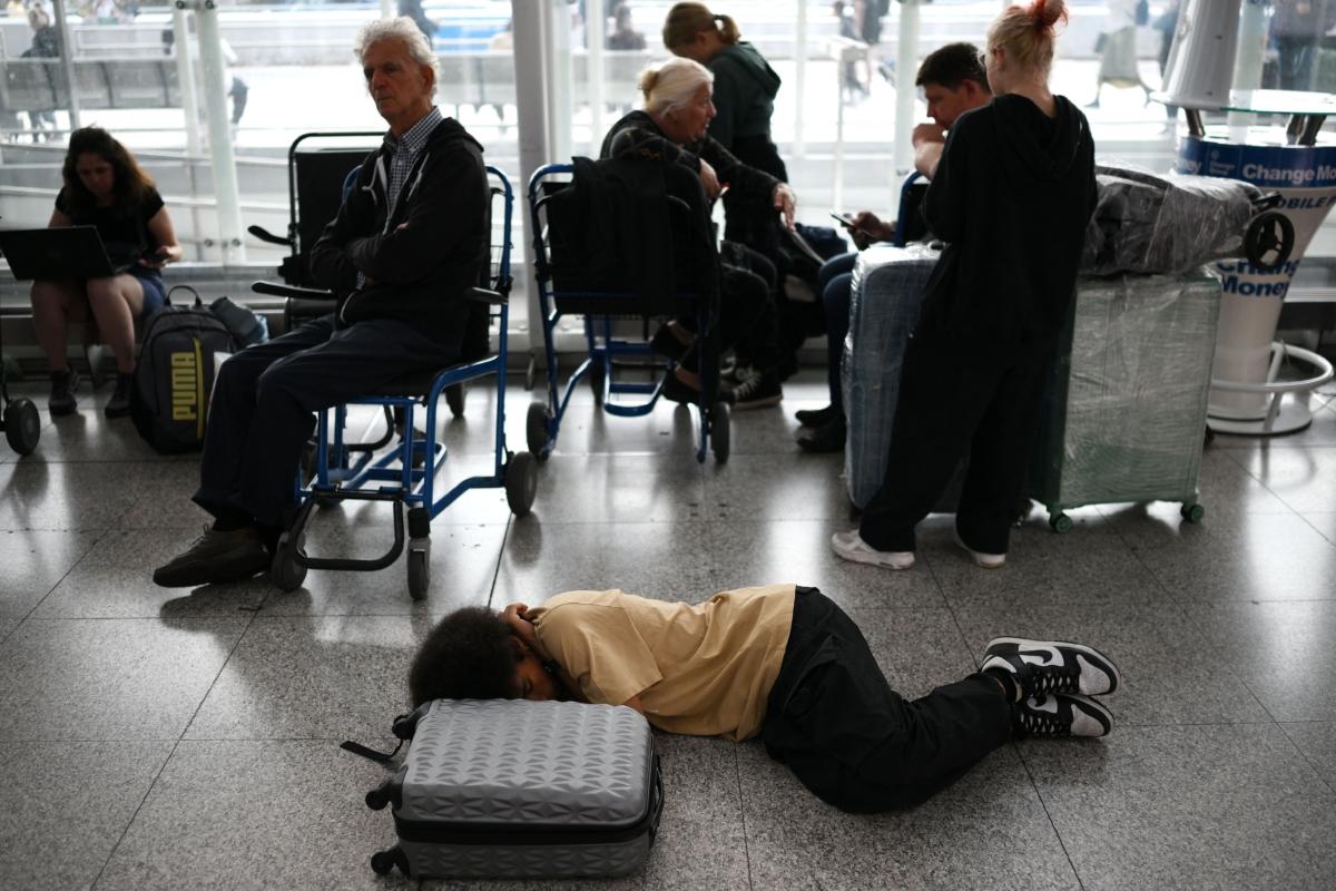 Passengers wait at Stansted Airport, north of London, after UK flights were delayed over a technical issue, on Aug. 29, 2023. (Daniel Leal/AFP via Getty Images)