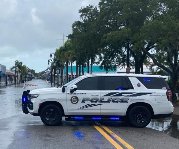 A police car in Tarpon Springs, Fla., blocks motorists from driving near the historic sponge docks after Hurricane Idalia passes, on Aug. 30, 2023. (John Haughey/The Epoch Times)