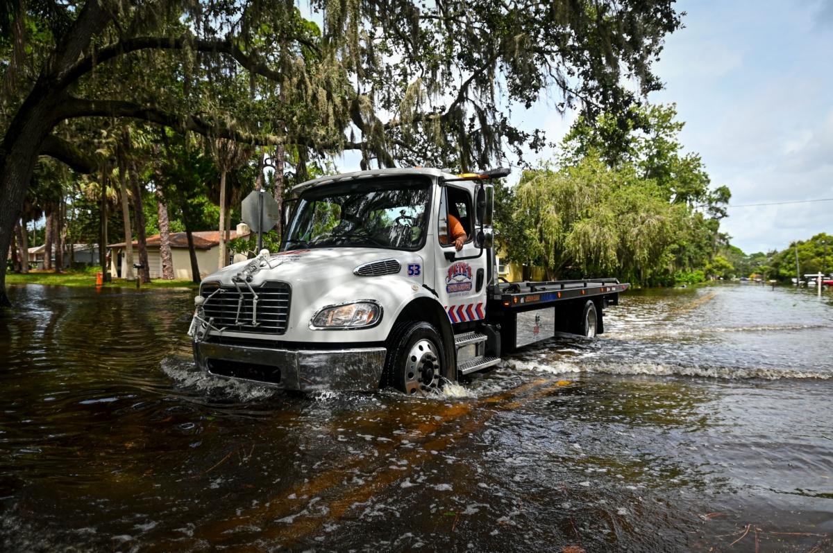 A tow truck drives through flood waters in New Port Richey, Fla., after Hurricane Idalia made landfall on Aug. 30, 2023. (Miguel J. Rodriguez Carrillo/AFP via Getty Images)