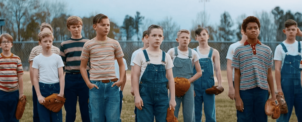 Rickey Hill (Jesse Berry, front and center in overalls) and big brother Robert Hill (Mason Gillett, to Rickey's left) play baseball with a group of boys in a new neighborhood they don't know yet, in "The Hill."