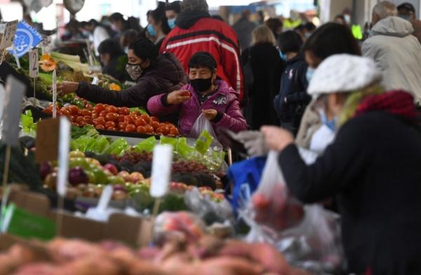 People shop for fruit and vegetables at a market in Melbourne, Australia, on June 11, 2021. (William West/AFP via Getty Images)