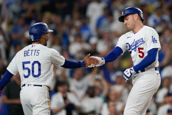 Los Angeles Dodgers' Freddie Freeman (5) celebrates his two-run home run against the Arizona Diamondbacks with Mookie Betts (50) during the third inning of a baseball game in Los Angeles on Aug. 30, 2023. (Ryan Sun/AP Photo)