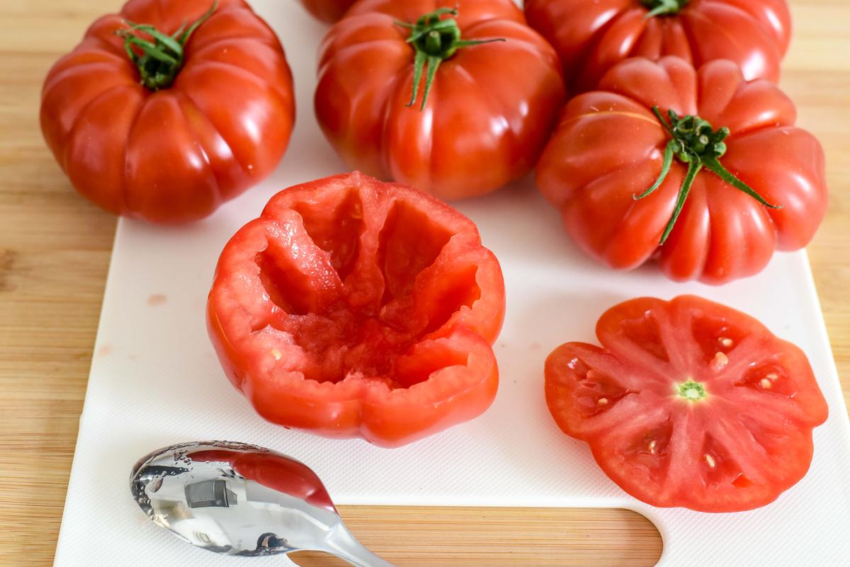 Slice off the tops of the tomatoes and carve out the insides. (Audrey Le Goff)