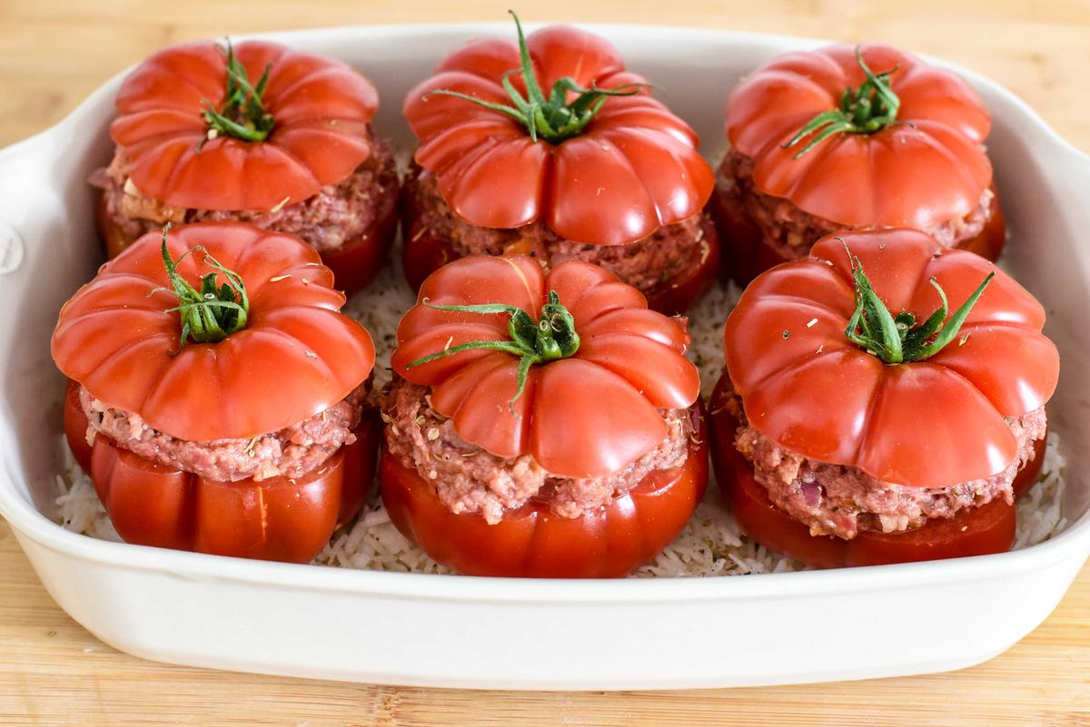 Top with the reserved tomato tops, drizzle with olive oil, and bake. (Audrey Le Goff)