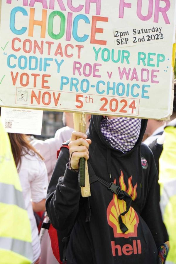 A pro-abortion protester holds a sign calling for Roe v. Wade to be codified into U.S. law, at a counter-protest as thousands took to the streets for the March for Life UK, in London, on Sept. 2, 2023. (Sophia Rumpus)