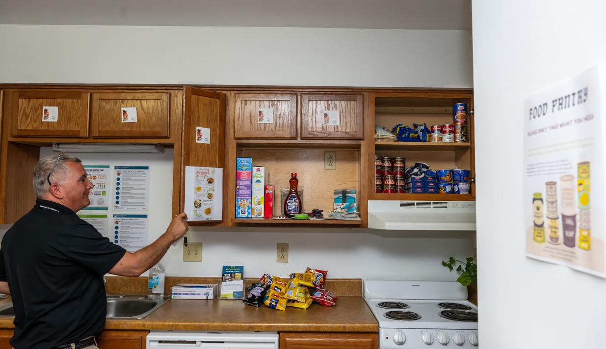 Mark Bellemare from Pittsburgh Technical College closes the cupboards in the food pantry in one of the dorms on campus on Monday, July 24, 2023. (Lucy Schaly/Pittsburgh Post-Gazette/TNS)
