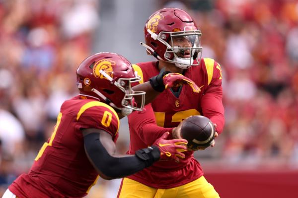 Caleb Williams (13) of the USC Trojans hands the ball to teammate MarShawn Lloyd (0) during the first quarter against the Nevada Wolf Pack at United Airlines Field at the Los Angeles Memorial Coliseum in Los Angeles on Sept. 2, 2023. (Katelyn Mulcahy/Getty Images)