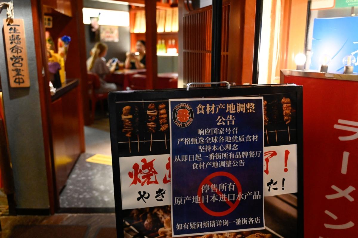 A sign reading "Suspend the sale of all fish products imported from Japan" in an area of Japanese restaurants in Beijing on Aug.  27, 2023. (Pedro Pardo/AFP via Getty Images)