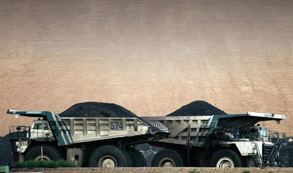 Coal trucks pass each other at BHP Billiton's Mt Arthur coal mine in Muswellbrook, Australia, on Feb. 15, 2006. (Ian Waldie/Getty Images)