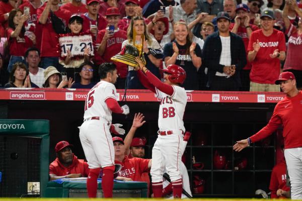 Los Angeles Angels' Randal Grichuk, front left, is given a Japanese kabuto after hitting a home run during the fourth inning of a baseball game against the Baltimore Orioles in Anaheim, Calif., on Sept. 4, 2023. (Ryan Sun/AP Photo)