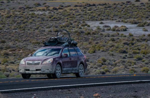 A muddy car drives away from the Burning Man festival in Black Rock, Nev., on Sep. 4, 2023. (John Fredricks/The Epoch Times)