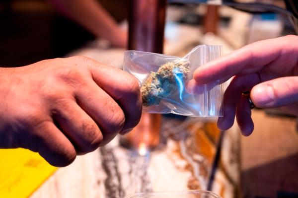 A customer buys marijuana in a coffee shop in the city centre of Amsterdam, Netherlands on Jan. 8, 2021. (Evert Elzinga/ANP/AFP via Getty Images)
