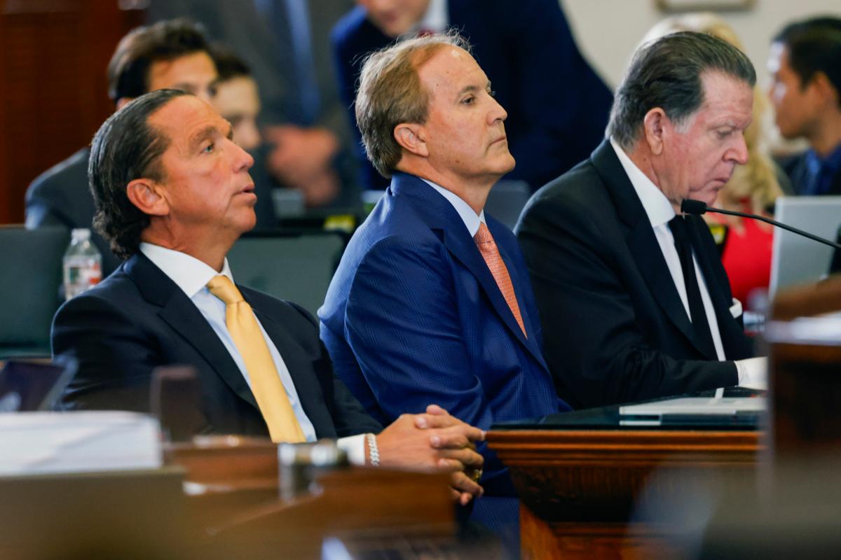 Texas state Attorney General Ken Paxton (C) sits with his attorneys Dan Cogdell (R) and Tony Buzbee during his impeachment trial in the Senate Chamber at the Texas Capitol in Austin on Sept. 5, 2023. (Juan Figueroa/The Dallas Morning News via AP)