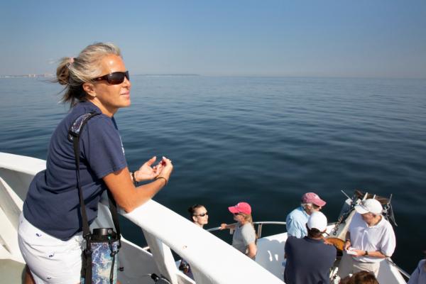 Conservation biologist and founder of the SaveOurWhalesNow organization Trisha DeVoe on Sept 6., 2023, off the Jersey Shore. (Richard Moore/The Epoch Times)