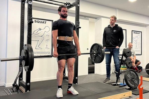 Personal trainer Steve Ross works with a client in strength training. (Courtesy of Starting Strength)