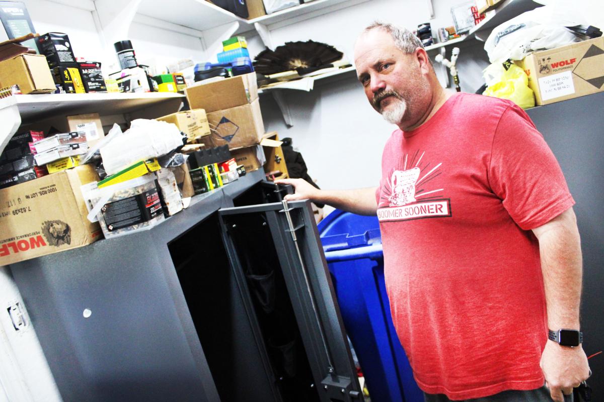 Russell Fincher stands in front of one of his gun safes emptied by the Bureau of Alcohol, Tobacco, Firearms and Explosives during a June 16, 2023 raid on his home in Tuskahoma, Okla., in this Sept. 1, 2023 photo. (Michael Clements/The Epoch Times)