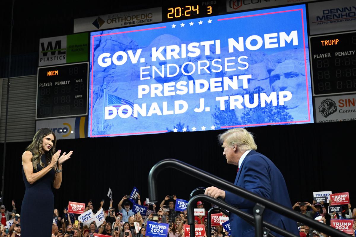  South Dakota Gov. Kristi Noem welcomes former president and 2024 Republican Presidential hopeful Donald Trump to the stage during the South Dakota Republican Party's Monumental Leaders rally at the Ice Arena at the Monument in Rapid City, S.D., on Sept. 8, 2023. (Andrew Caballero-Reynolds/AFP via Getty Images)