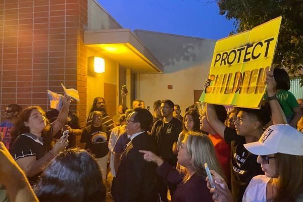 Community members gather outside of an Orange Unified School Board meeting, during which the board passes a policy to notify parents when their child wishes to identify as transgender, in Orange, Calif., on Sept. 7, 2023. (Mei Lee/The Epoch Times)