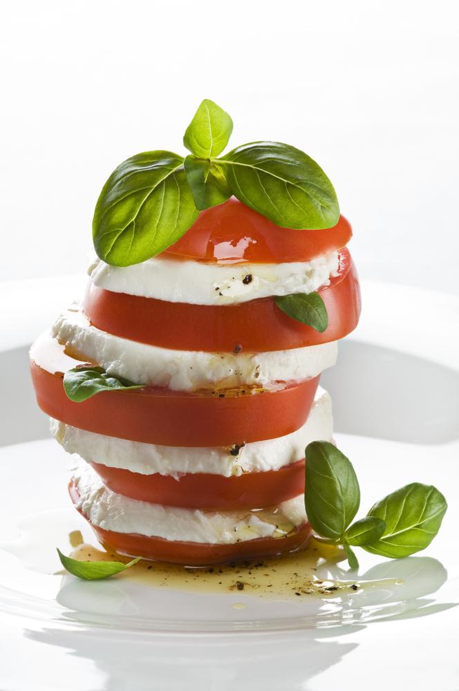  A caprese can be stacked into a tower, with the slice of cheese as the foundation topped with basil and a slice of tomato. (DUSAN ZIDAR/Shutterstock)