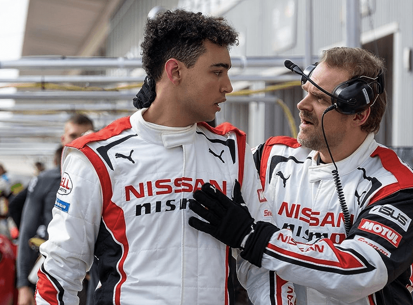 Jann Mardenborough (Archie Madekwe, L) being given racing advice by veteran driver and coach Jack Salter (David Harbour), in "Gran Turismo." (Sony Pictures Releasing)