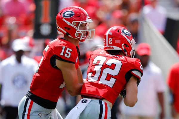 Carson Beck (15) of the Georgia Bulldogs hands off to Cash Jones (32) during the third quarter against the Ball State Cardinals at Sanford Stadium in Athens, Georgia on Sept. 9, 2023. (Todd Kirkland/Getty Images)
