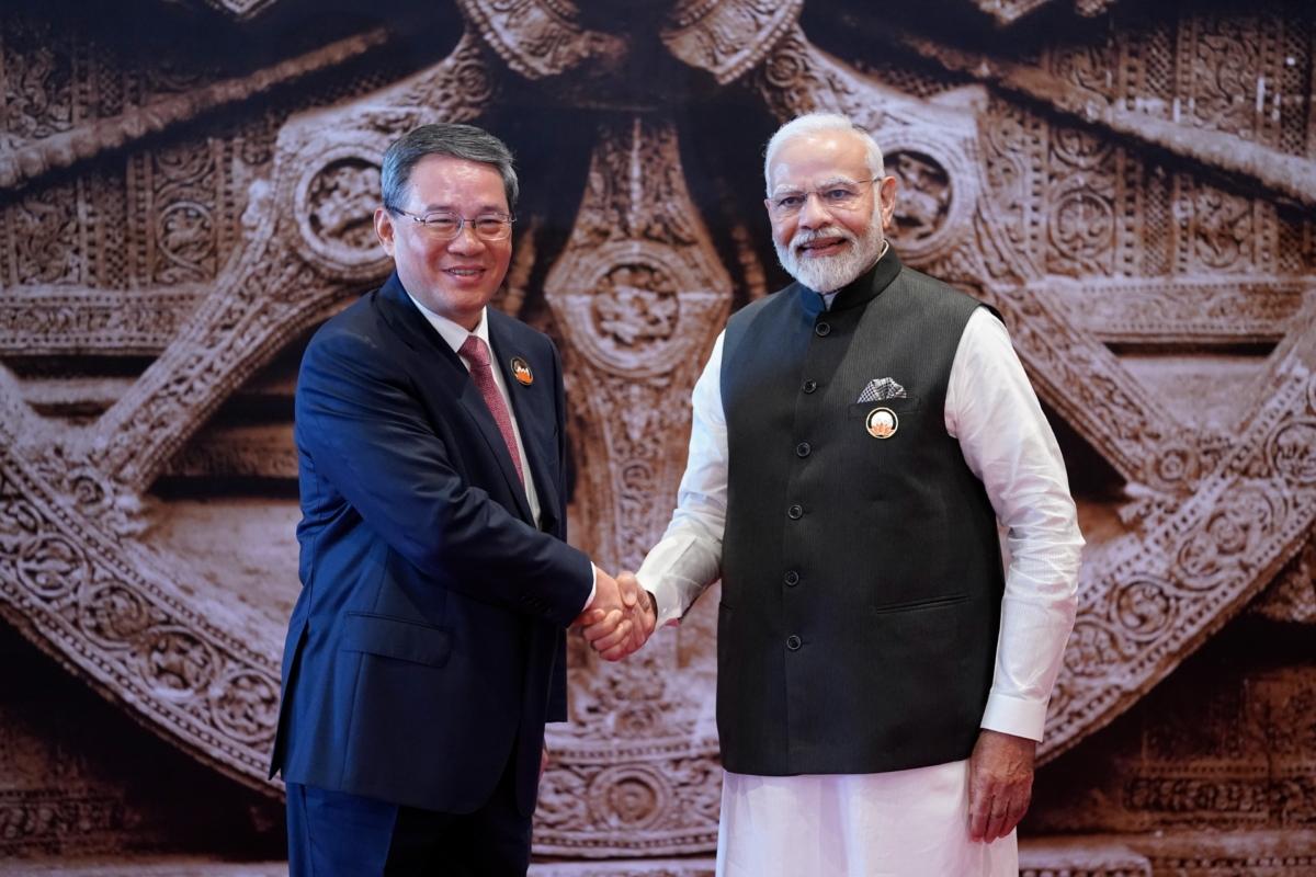 Indian Prime Minister Narendra Modi (R), shakes hands with Chinese Premier Li Qiang upon his arrival at Bharat Mandapam convention center for the G20 Summit in New Delhi, India, on Sept. 9, 2023. (Evan Vucci/Pool/AP Photo)