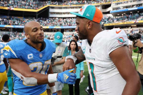 Tua Tagovailoa (1) of the Miami Dolphins talks with Austin Ekeler (30) of the Los Angeles Chargers after the Dolphins defeated the Chargers at SoFi Stadium in Inglewood, Calif., on Sept. 10, 2023. (Kevork Djansezian/Getty Images)